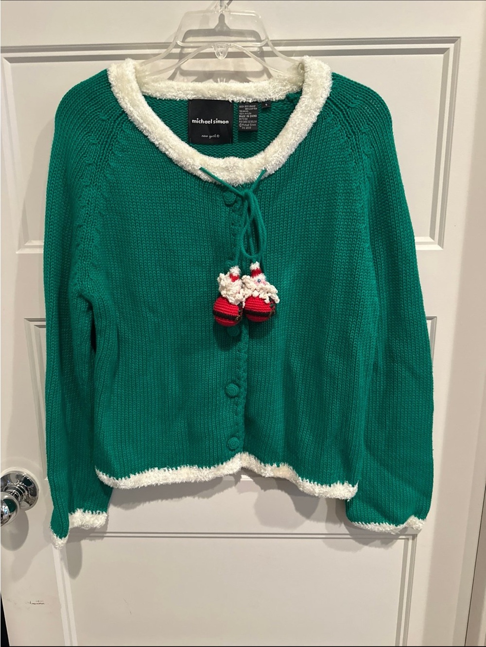 Michael Simon emerald green cardigan with white trim and red pom-poms